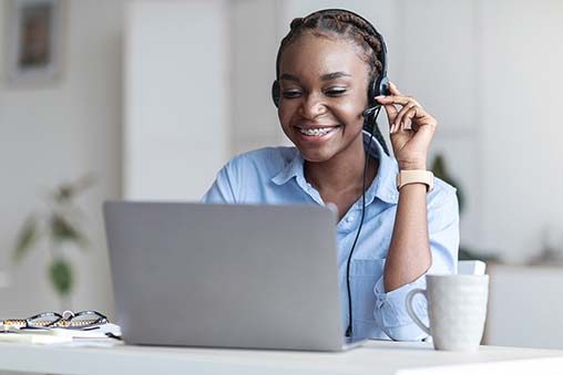 Customer Support. Black woman manager wearing headset and using